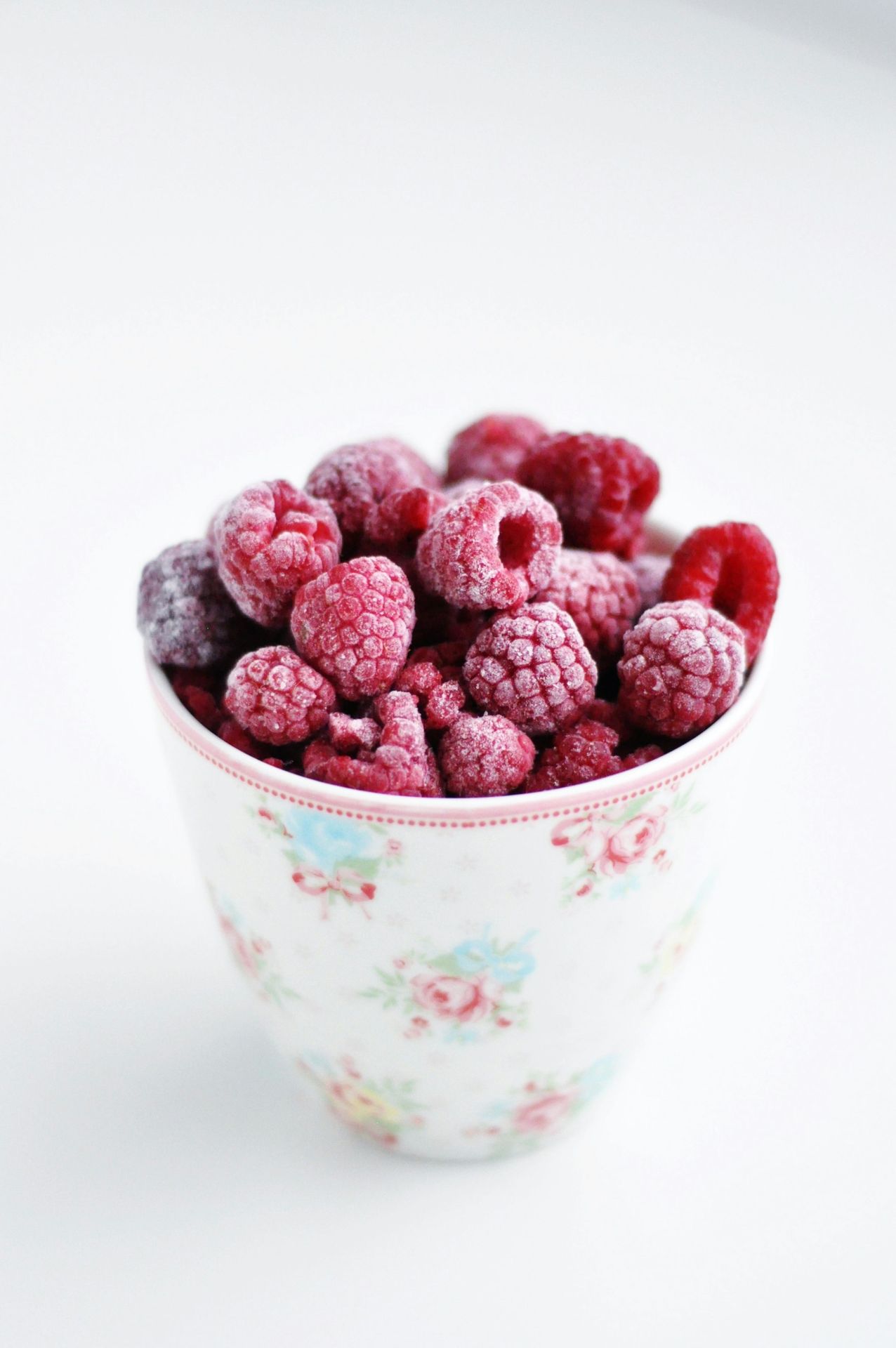 raspberry on white and pink floral ceramic cup